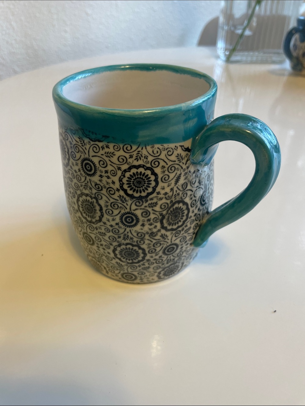 Blue Trim Ceramic Mug with Black Floral Pattern